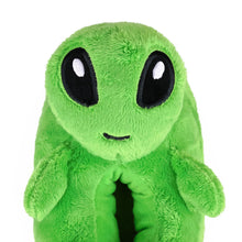 Green plush Alien Slipper with large black eyes on a white background, close up view of face