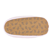 Bottom of an Axolotl slipper, showing a faux suede sole with non-slip grips.