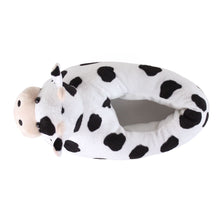Plush slipper shaped like a cow on a white background