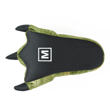 Green dinosaur claw slipper turned upside down to show black fabric sole with non-slip grips